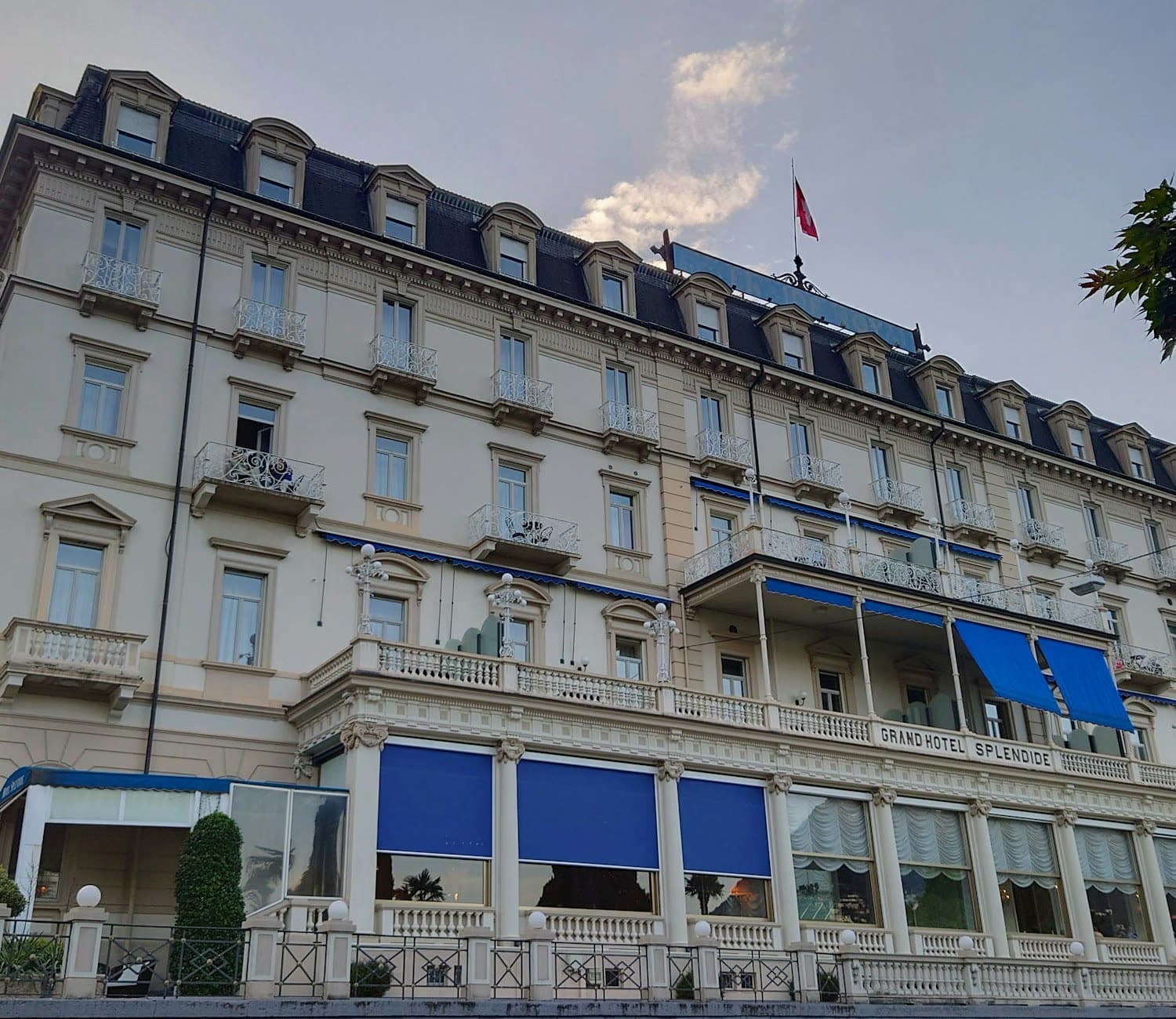 The façade of a belle-époque city-centre hotel at dusk