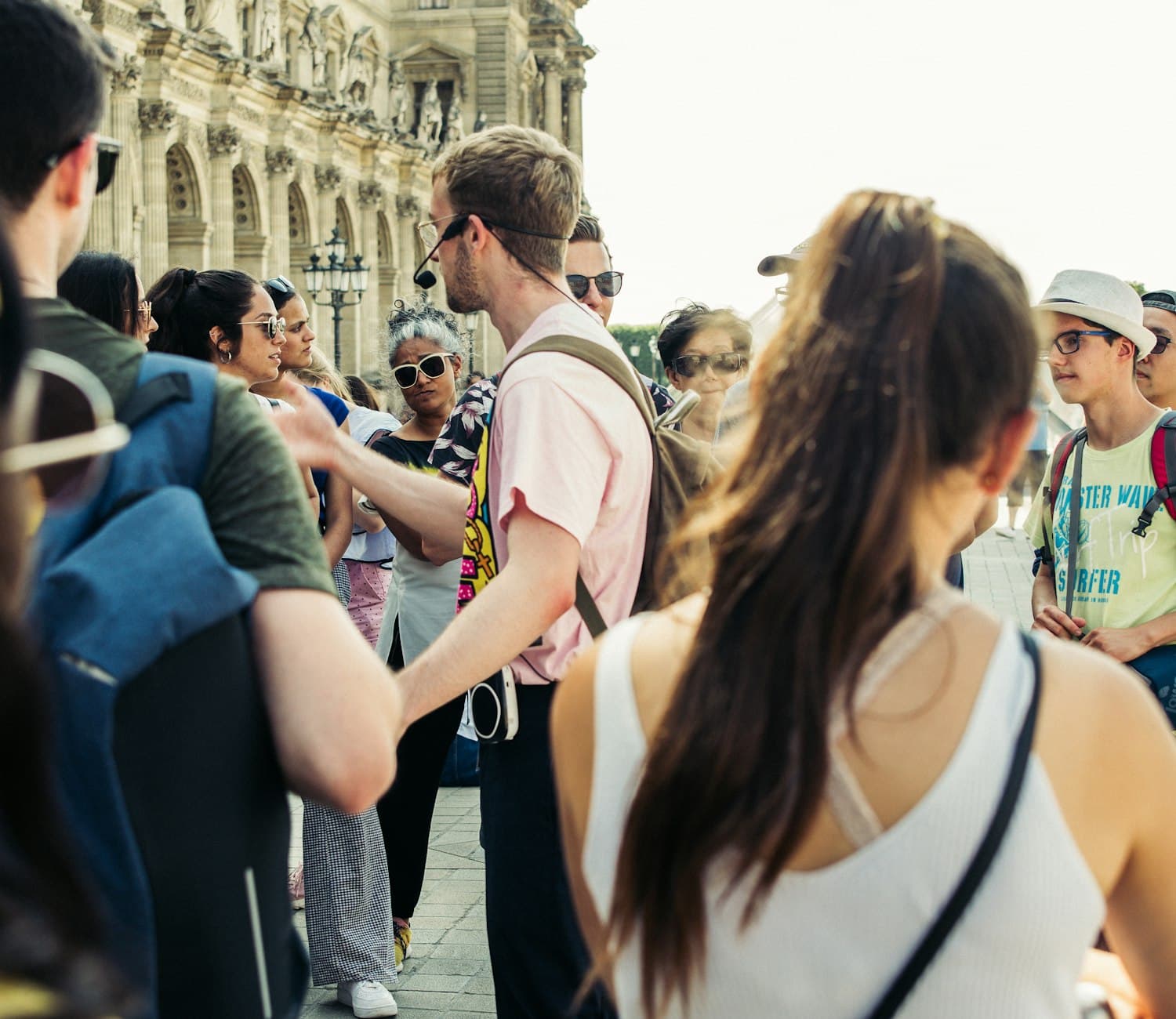 A guide talking to a small group of travellers on a Paris street